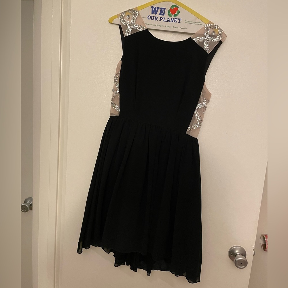 Formal knee length dress. Sheer on the sides with jewel details